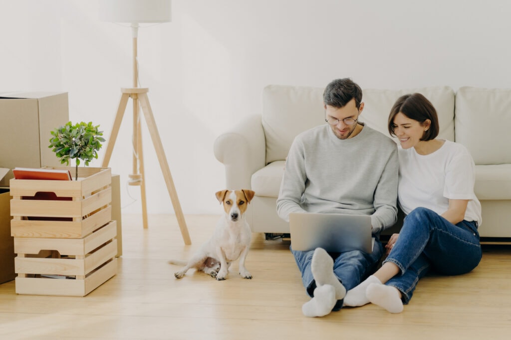 Couple looking at laptop together reviewing aggressive debt restructuring plan