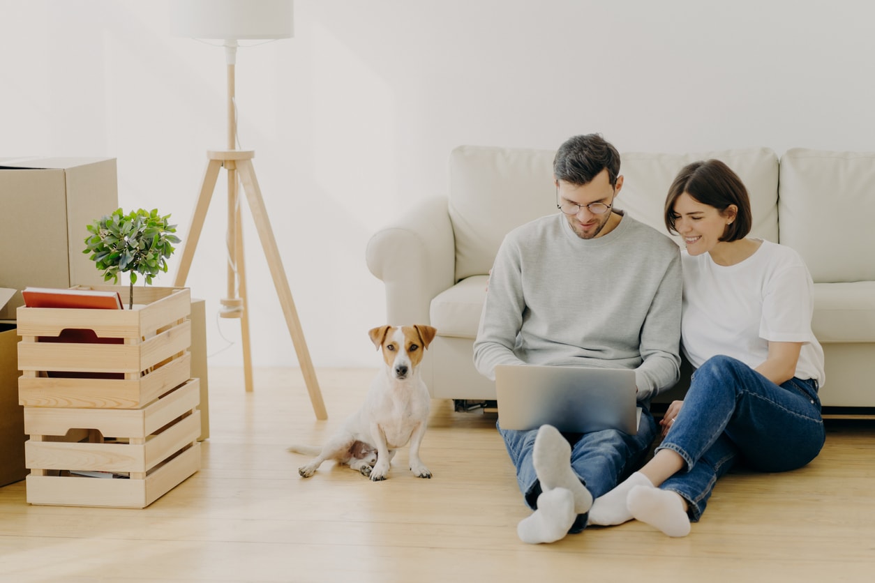 Couple looking at laptop together reviewing aggressive debt restructuring plan