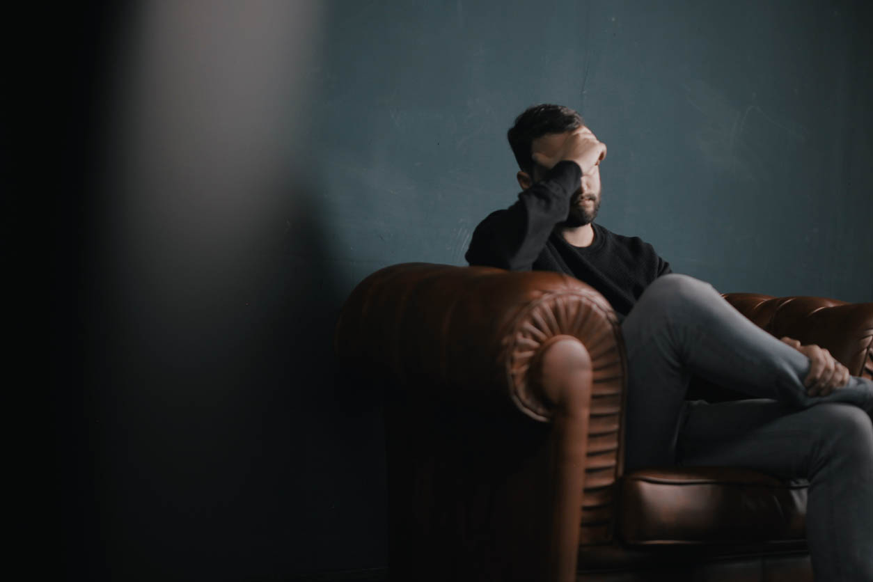 man worrying about debt and his health
