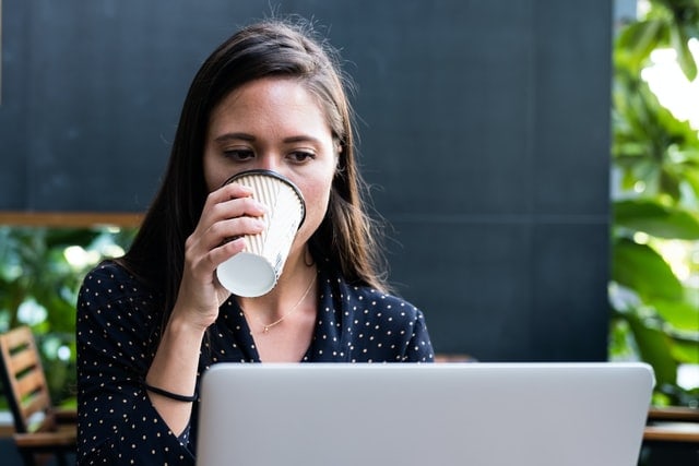woman on her computer looking at mortgage debt options